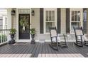 Inviting front porch with rocking chairs, potted plants, and decorative details, offering a cozy outdoor space at 515 Saint Barbaras Nw Ln, Marietta, GA 30064