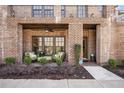 Cozy covered porch with brick columns, ceiling fan, and comfortable seating area, offering a relaxing outdoor space at 6838 Prelude Dr, Atlanta, GA 30328