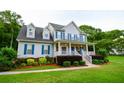 Attractive two-story home with blue shutters, a covered front porch, and manicured lawn at 855 Hood Rd, Fayetteville, GA 30214