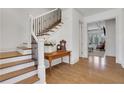 Inviting foyer with hardwood floors, staircase with iron railing, and decorative table with floral arrangement at 2620 Middle Coray Cir, Marietta, GA 30066