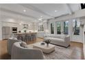 Bright living room open to kitchen features a modern sofa, stylish chairs, and hardwood floors at 2620 Middle Coray Cir, Marietta, GA 30066