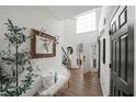 Bright foyer with hardwood floors, stylish decor, and open staircase leading to the upper level at 7880 Brands Hatch Blvd, Cumming, GA 30040