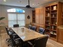 Well-appointed conference room with a large granite table, executive chairs, and custom built-in cabinetry at 1075 Peachtree Walk # A205, Atlanta, GA 30309