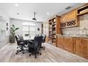 Stylish conference room with hardwood-style floors, large table, and built-in shelving with wet bar at 1075 Peachtree Walk # A205, Atlanta, GA 30309