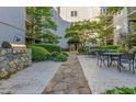 Beautifully landscaped courtyard featuring stone walkways, tables, and a built-in gas grill at 1075 Peachtree Walk # A205, Atlanta, GA 30309