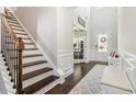 Welcoming foyer featuring hardwood floors, staircase, and a bright, inviting entrance at 2031 Broadmoor Way, Fairburn, GA 30213