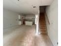 Spacious unfinished interior with stairs and kitchen area showcasing potential for customization at 4428 Ryan St, Douglasville, GA 30135