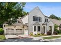 Beautifully landscaped two-story white brick home with attached two-car garage and an inviting front entrance at 10580 Grandview Sq, Johns Creek, GA 30097