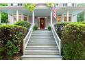 Inviting staircase leads to a red front door with white railings and manicured shrubs at 2789 Brookcliff Lndg, Marietta, GA 30062