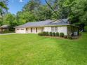 Well-maintained single story home with lush front yard and a convenient side entrance garage at 4062 Plantation Dr, Marietta, GA 30062