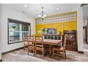 Bright dining room featuring wood floors, stylish accent wall and large window at 48 Old Canton Ne Rd, Cartersville, GA 30121