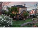 Backyard featuring a charming deck, lush lawn, and mature landscaping at 1029 Fairway Ne Ests, Atlanta, GA 30319