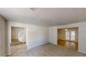 Open-concept living room with carpeting, tiled dining area and staircase at 625 Compton Ln, Mcdonough, GA 30253