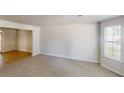 Spacious living room with plush carpeting and a large window at 625 Compton Ln, Mcdonough, GA 30253
