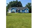 Inviting blue house with lush green lawn and an American flag proudly displayed at 160 Springdale Ct, Newborn, GA 30056