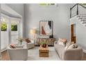 Bright living room with large windows, neutral color palette, hardwood floors, and comfortable seating at 3699 Canyon Ridge Ne Ct, Brookhaven, GA 30319