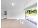Spacious, covered carport with painted floors and convenient side door access at 6243 David Sw Ln, Mableton, GA 30126