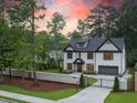 Stunning two-story home features a manicured front yard, driveway, and a gated entrance at 4955 Chamblee Dunwoody Rd, Dunwoody, GA 30338