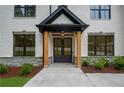 Inviting front entrance featuring double doors, wooden pillars, and stone accents at 4955 Chamblee Dunwoody Rd, Dunwoody, GA 30338