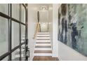 Inviting entryway with stairs featuring wood treads, white risers, and stylish decor at 565 Rose Garden Ln, Alpharetta, GA 30009