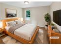 Staged bedroom featuring neutral colors, carpet floors, and a window with natural light at 690 Horsley Mill Rd, Carrollton, GA 30116