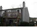 Exterior of gray two-story townhouse with a wooden balcony overlooking the backyard at 1026 Riverbend Club Se Dr, Atlanta, GA 30339