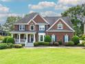 Stunning two-story brick home with landscaped lawn, inviting front porch and beautiful blue shutters at 1409 Echo Mill Dr, Powder Springs, GA 30127