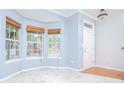 Bright living room with bay window and woven shades, complemented by marble floors and neutral wall color at 2594 Laurel Nw Cir, Atlanta, GA 30311
