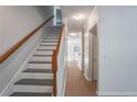Bright entryway featuring a staircase with wood railing and neutral flooring at 2594 Laurel Nw Cir, Atlanta, GA 30311