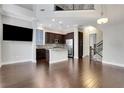 Open-concept living area featuring hardwood floors, modern light fixtures, and a stylish kitchen view at 3005 Devoncroft Se St, Smyrna, GA 30080