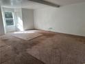 Spacious living room featuring carpet flooring and natural light from large windows at 4232 Marjorie Rd, Snellville, GA 30039
