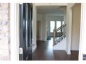 Inviting foyer with hardwood floors and a staircase featuring iron balusters at 150 Canal St, Hampton, GA 30228