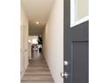 Inviting hallway with modern gray door, leading to an open-concept living area at 1577 Aiden Way # 39, Conyers, GA 30013