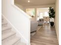Bright open-plan featuring a staircase and view into living/dining area and kitchen at 1577 Aiden Way # 39, Conyers, GA 30013