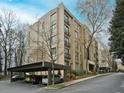 Low angle exterior view of a multi-story building with covered parking and mature trees at 2769 Peachtree Ne Rd # 10, Atlanta, GA 30305