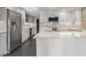 Bright kitchen featuring stainless steel appliances, white cabinets, and a marble countertop island at 2769 Peachtree Ne Rd # 10, Atlanta, GA 30305