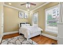 Cozy bedroom featuring a ceiling fan, plush rug, and natural light from two windows at 384 16Th Nw St # 1, Atlanta, GA 30363