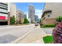Urban street view featuring modern buildings, lush greenery, and a glimpse of the city skyline at 384 16Th Nw St # 1, Atlanta, GA 30363