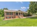 A well-maintained brick home with black shutters, landscaping, and a welcoming front porch at 7928 S Giles Rd, Douglasville, GA 30135