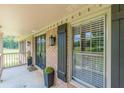 Inviting front porch with classic columns, black door, and lush landscaping details at 7928 S Giles Rd, Douglasville, GA 30135