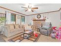 Comfortable living room with a stone fireplace, plush seating, and natural light, perfect for relaxation at 403 Rustic Ridge Cir, Lawrenceville, GA 30043