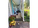 View of home's cozy front porch, featuring comfortable seating and vibrant potted plants at 4298 Hillview Dr, Acworth, GA 30101