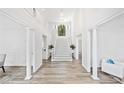 Grand foyer featuring a soaring ceiling, staircase, and hardwood floors at 515 Old Chartwell Xing, Alpharetta, GA 30022