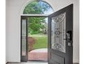 Elegant front door with decorative glass and sidelights, providing a glimpse of the landscaped yard at 515 Old Chartwell Xing, Alpharetta, GA 30022