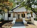 Charming front porch of a renovated home featuring wooden columns and a decorative railing at 1766 W Lyle W Ave, College Park, GA 30337