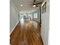 Spacious open-concept living room and kitchen, showcasing hardwood floors and a bright, airy atmosphere at 1766 W Lyle W Ave, College Park, GA 30337