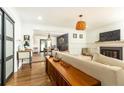 Bright and inviting living room featuring hardwood floors, fireplace, and modern lighting at 1443 Fama Ne Dr, Atlanta, GA 30329