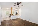 Inviting living room with hardwood floors, ceiling fan, and an open view to the kitchen area at 1636 Mary George Nw Ave, Atlanta, GA 30318