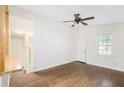Bright living room features beautiful hardwood floors, ceiling fan, and a large window at 1636 Mary George Nw Ave, Atlanta, GA 30318