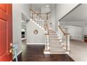 Bright foyer featuring hardwood floors, carpeted stairs, and high ceilings at 2342 Tall Timbers Ln, Marietta, GA 30066